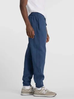 NEW BALANCE Pantaloni<PANTALONE JOGGER ATHLETICS FRENCH TERRY Blu, Nero
